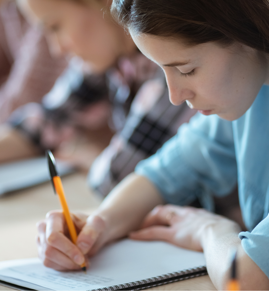 Shot of the Row of Students Writing in the Notebooks, Taking Exam